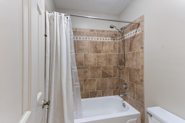 bathroom featuring shower / tub combo, a textured ceiling, and toilet