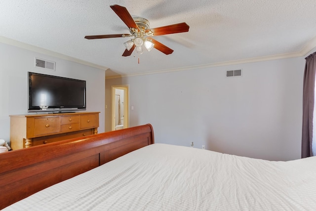 bedroom with visible vents, crown molding, and a textured ceiling