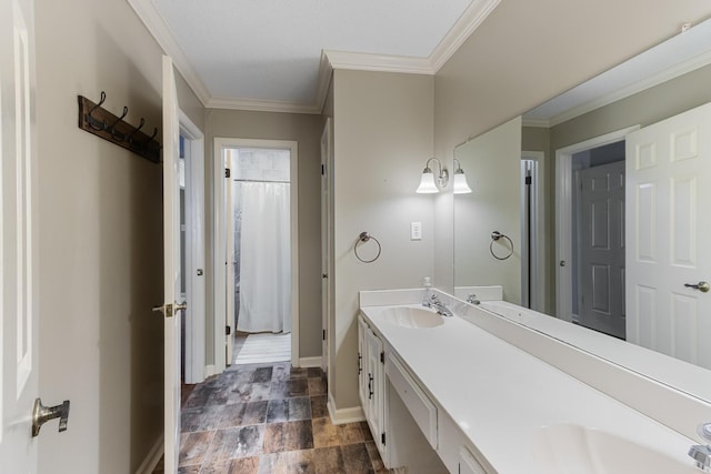 bathroom featuring crown molding, double vanity, a sink, and baseboards