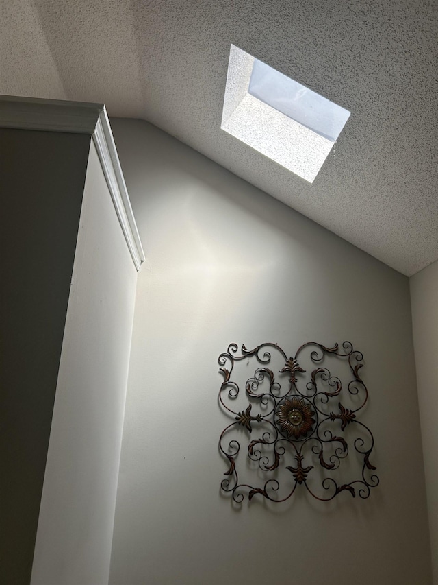 interior details featuring a skylight and a textured ceiling