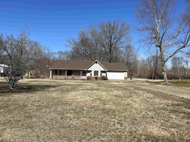 ranch-style house with a porch, a front lawn, driveway, and a garage