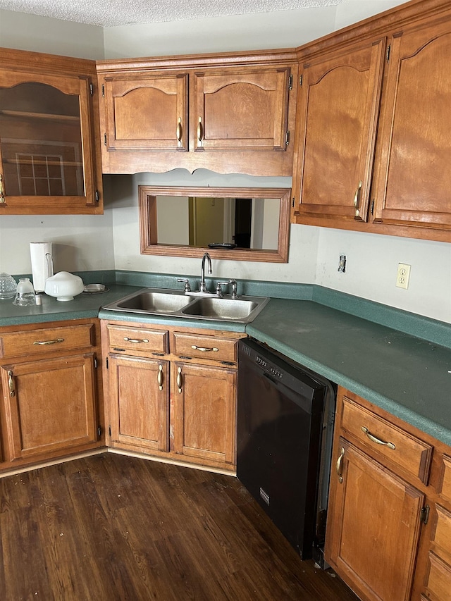 kitchen with brown cabinetry, black dishwasher, a sink, and dark wood-style flooring