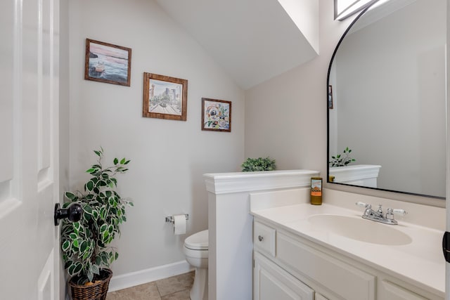 half bath featuring baseboards, toilet, lofted ceiling, tile patterned flooring, and vanity