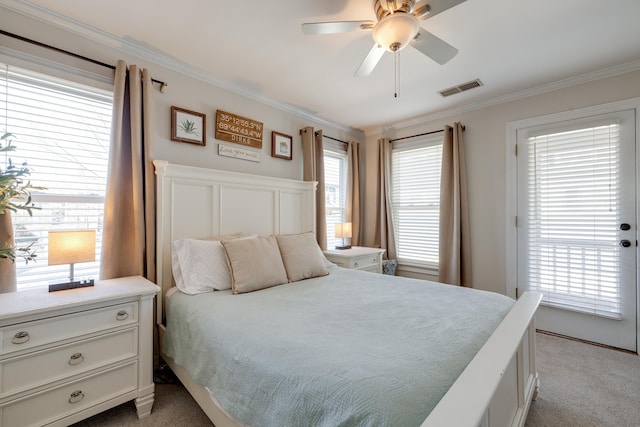 bedroom with ornamental molding, visible vents, carpet floors, and a ceiling fan