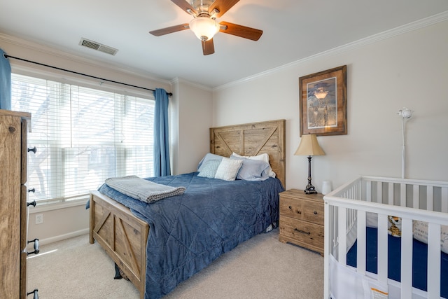 bedroom with light carpet, ceiling fan, visible vents, and ornamental molding