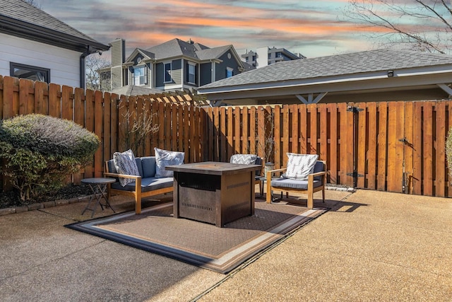 patio terrace at dusk featuring fence