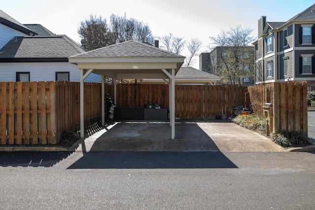 view of parking with fence