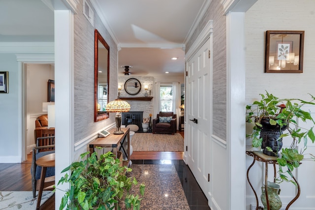 hall with wallpapered walls, visible vents, baseboards, crown molding, and granite finish floor