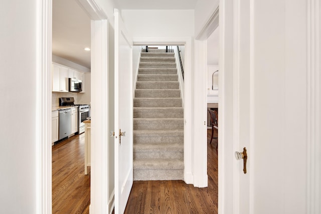 stairway featuring wood finished floors