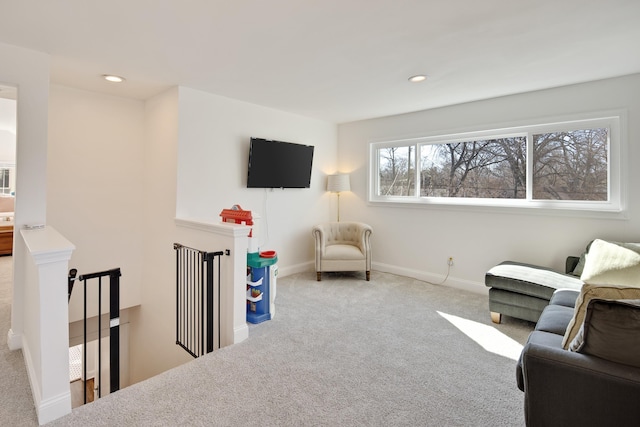 sitting room with recessed lighting, carpet flooring, an upstairs landing, and baseboards