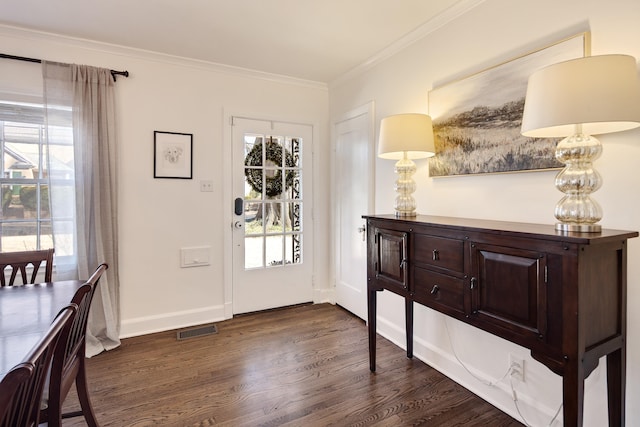 entryway with crown molding, dark wood-style flooring, visible vents, and a healthy amount of sunlight