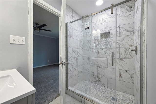 full bathroom featuring a stall shower, a ceiling fan, and crown molding