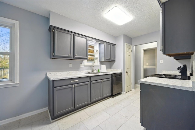 kitchen featuring electric range, baseboards, dishwasher, light countertops, and a sink