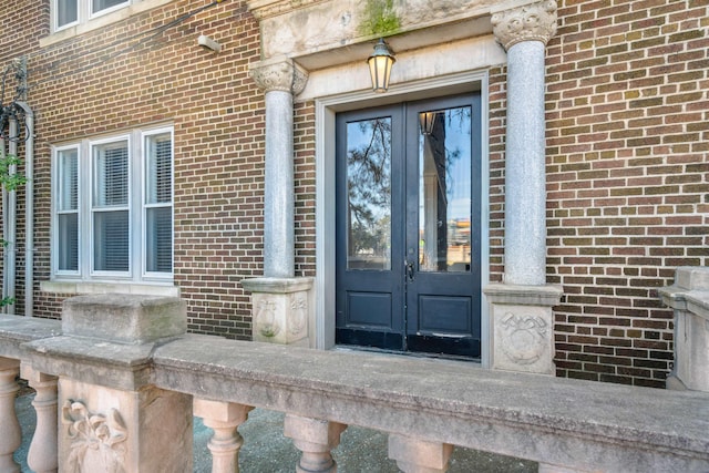 doorway to property with french doors and brick siding