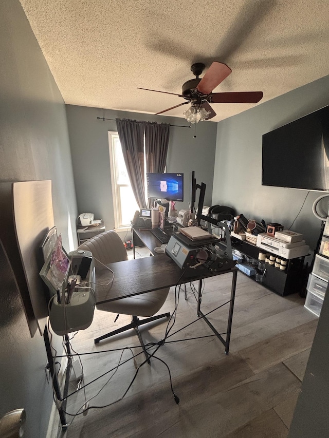 office area featuring ceiling fan, a textured ceiling, and wood finished floors
