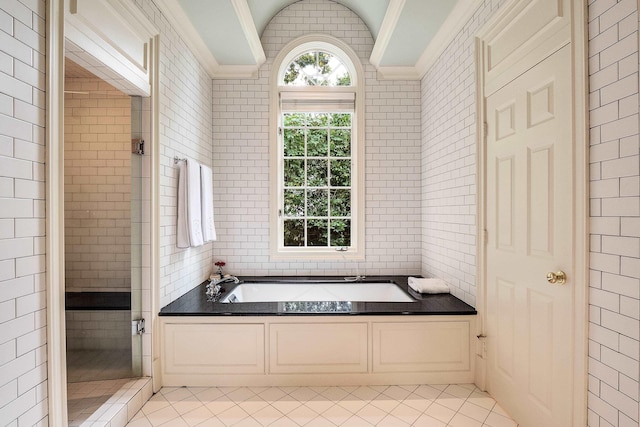 bathroom with tile patterned flooring, a garden tub, crown molding, and a shower stall