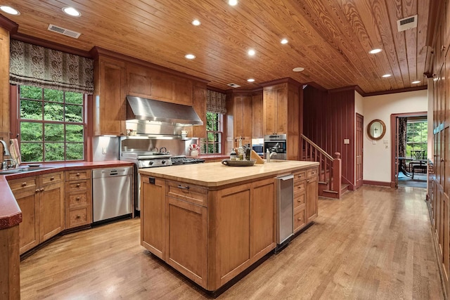 kitchen with an island with sink, wood counters, range hood, stainless steel dishwasher, and a sink