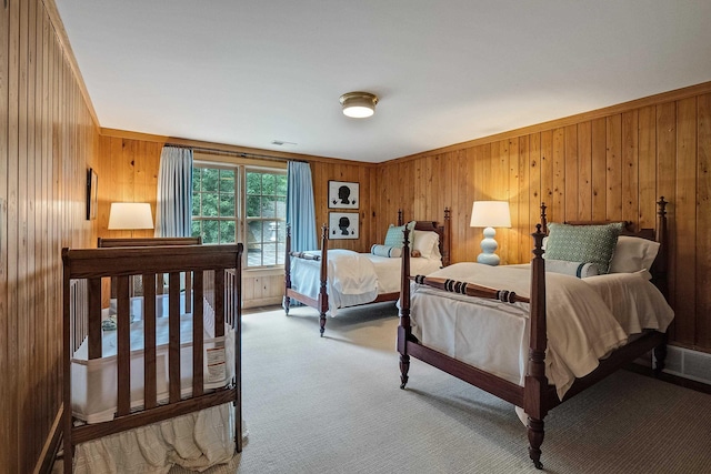 bedroom featuring carpet floors, visible vents, and wood walls