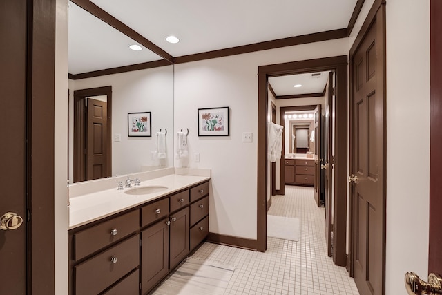 bathroom with baseboards, recessed lighting, vanity, and crown molding