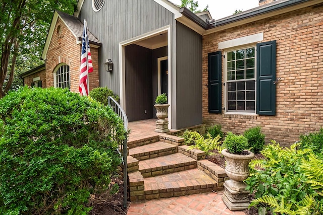 entrance to property featuring brick siding