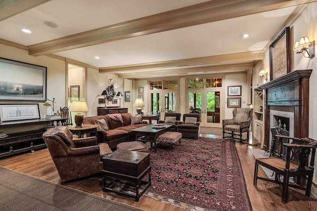 living area featuring french doors, beam ceiling, recessed lighting, a fireplace with flush hearth, and wood finished floors