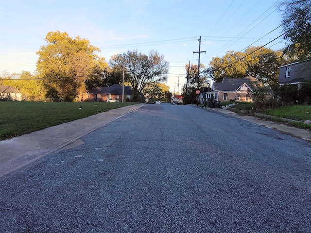 view of street featuring traffic signs, curbs, and sidewalks