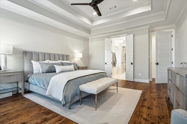 bedroom with ornamental molding, a raised ceiling, visible vents, and dark wood finished floors