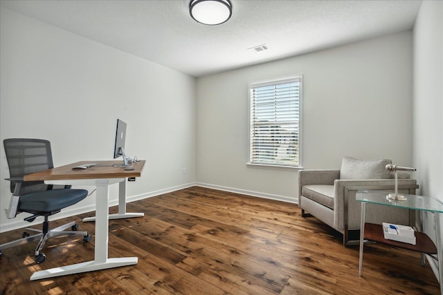 home office featuring visible vents, baseboards, and wood finished floors