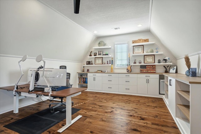 home office with lofted ceiling, a textured ceiling, and wood finished floors