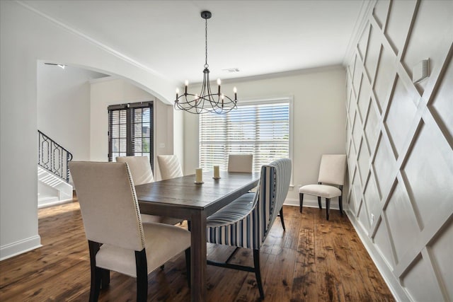 dining room with arched walkways, dark wood-style floors, stairs, and crown molding