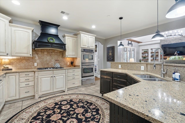 kitchen with stainless steel appliances, premium range hood, a sink, a warming drawer, and crown molding