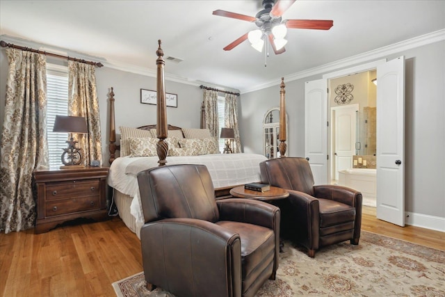 bedroom featuring light wood finished floors, ensuite bath, visible vents, and crown molding