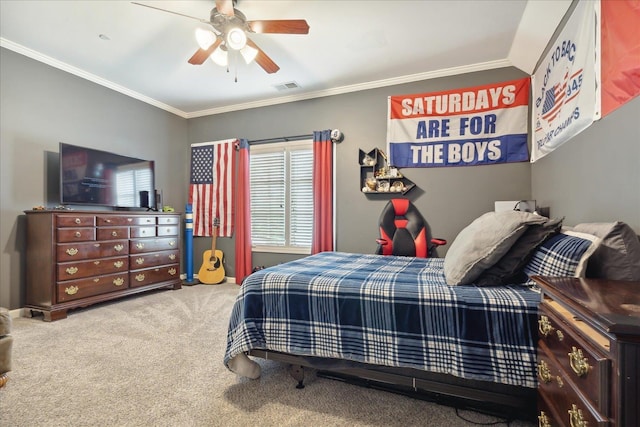 carpeted bedroom with visible vents, ornamental molding, and ceiling fan