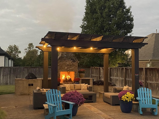 view of patio / terrace featuring a fenced backyard, an outdoor kitchen, an outdoor living space with a fireplace, and a pergola