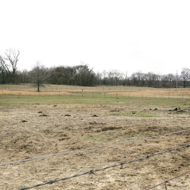 view of yard with a rural view and fence