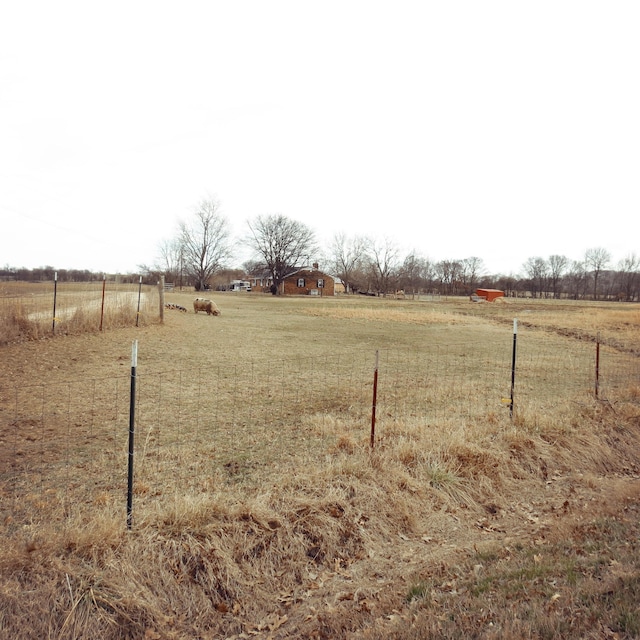 view of yard featuring a rural view and fence