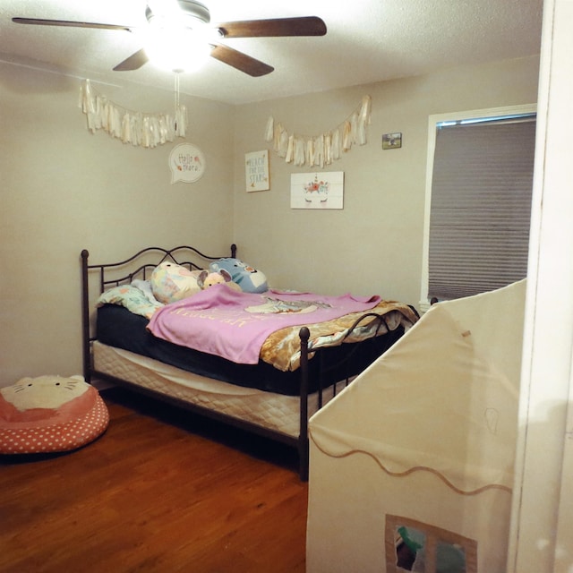 bedroom with ceiling fan and wood finished floors