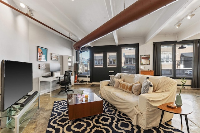 living room with beamed ceiling and baseboards