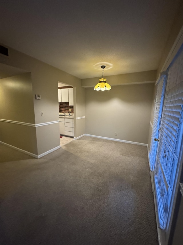 unfurnished room with light carpet, visible vents, and baseboards