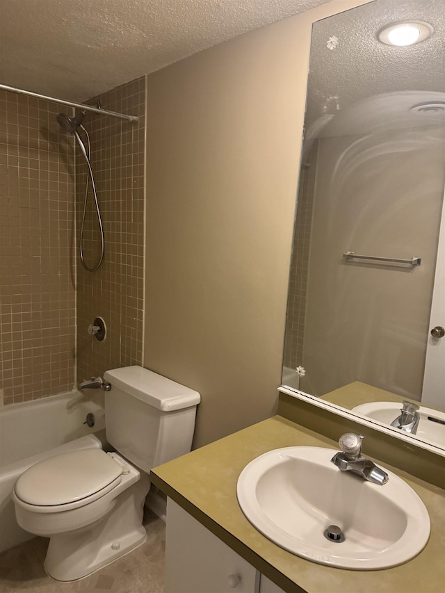 full bath featuring a textured ceiling, tub / shower combination, vanity, and toilet