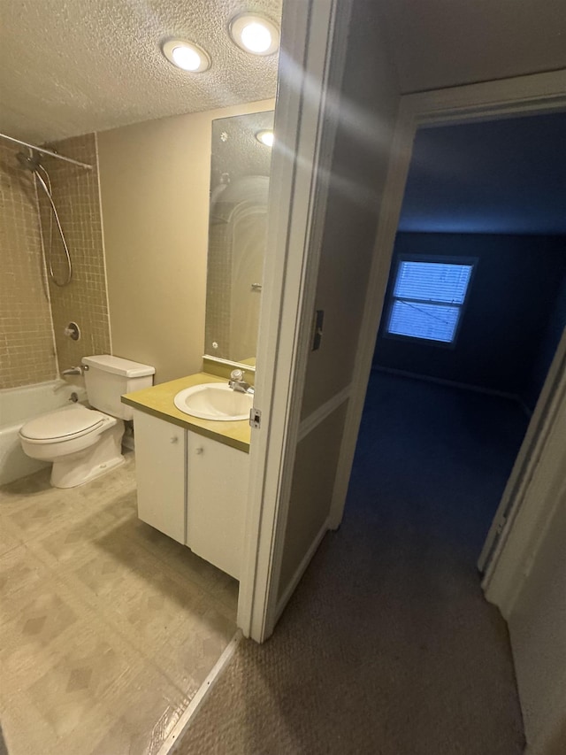 bathroom featuring a textured ceiling, toilet, bathtub / shower combination, and vanity