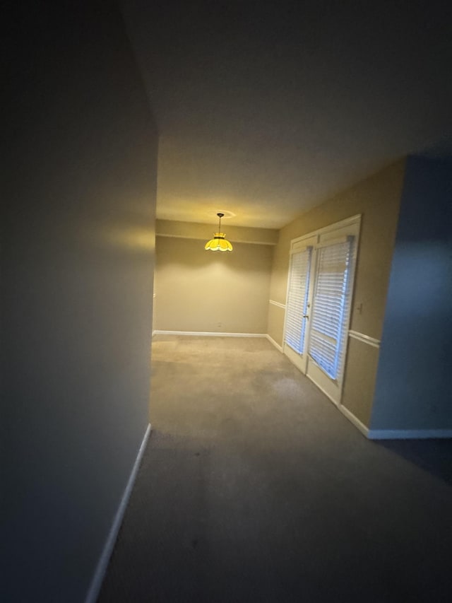 carpeted spare room with baseboards