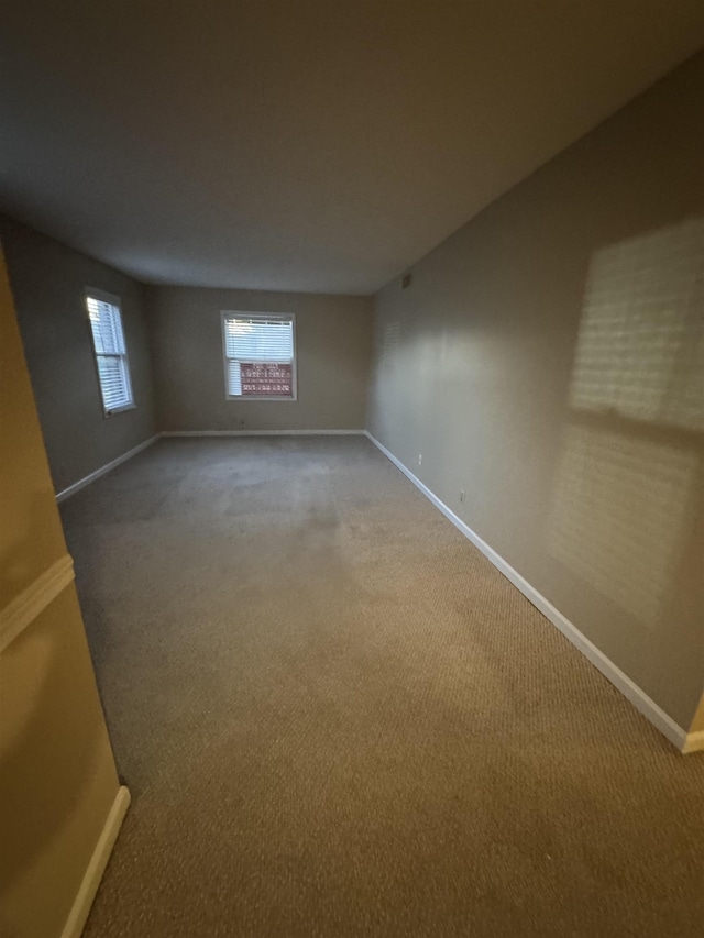 below grade area with carpet flooring and baseboards