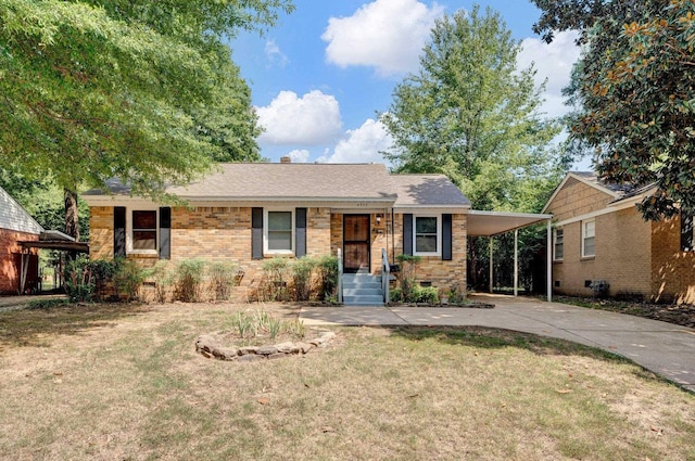 single story home with concrete driveway, an attached carport, a front yard, and brick siding