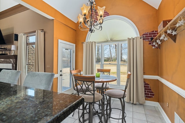 dining space featuring lofted ceiling, light tile patterned floors, visible vents, and an inviting chandelier