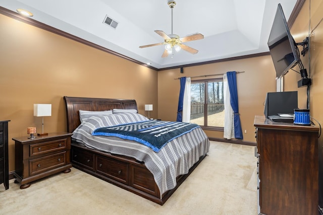 bedroom with baseboards, visible vents, a raised ceiling, and light colored carpet