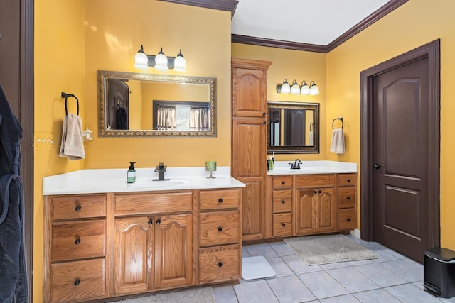 bathroom with ornamental molding, two vanities, a sink, and tile patterned floors