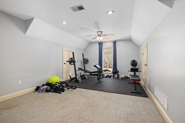 workout area with lofted ceiling, visible vents, a textured ceiling, and baseboards