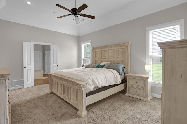 bedroom with baseboards, visible vents, a ceiling fan, and light colored carpet