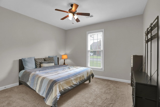 bedroom featuring carpet floors, baseboards, visible vents, and ceiling fan